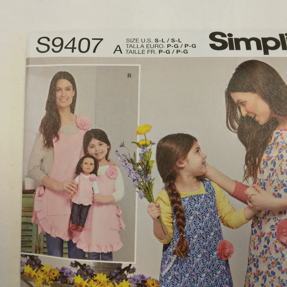 Simplicity S9407 Cute Aprons in adult child & American Girl Doll sizes.